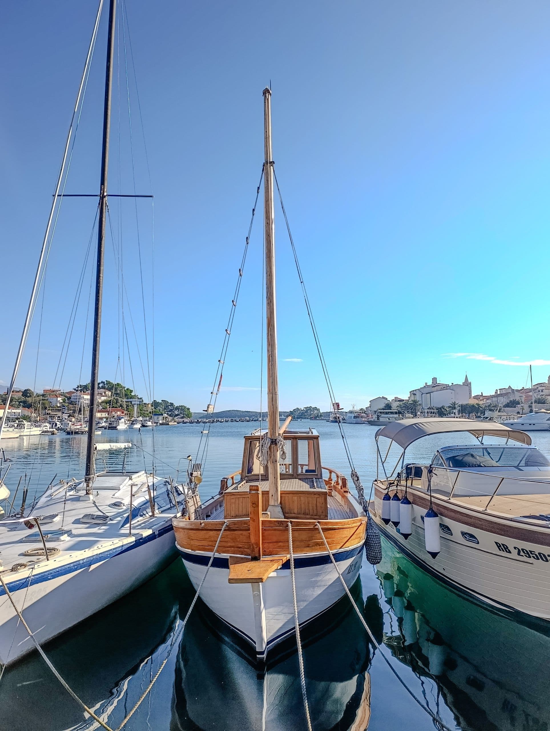 Sailboat moored in Rab old town harbour at first light.
